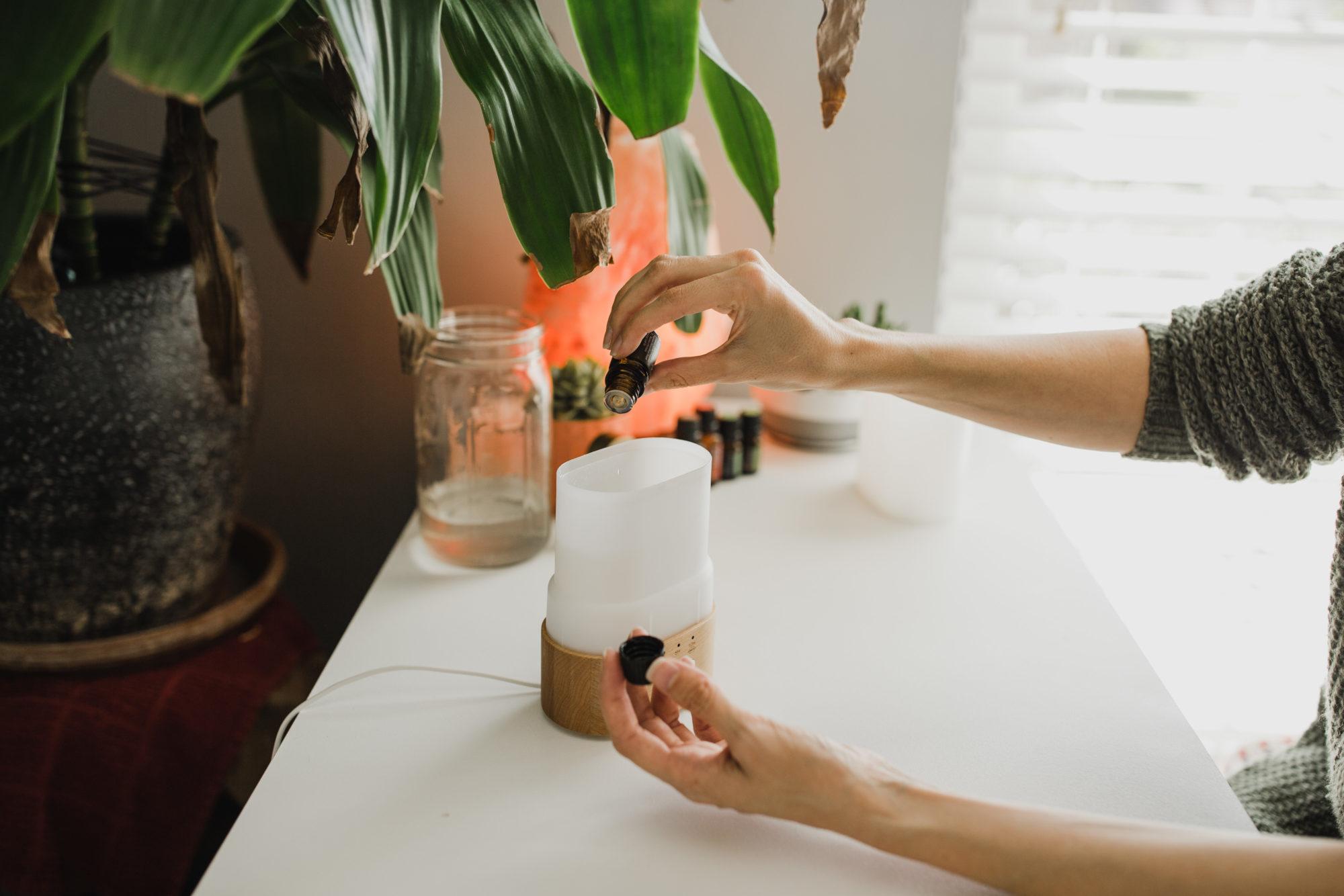 Tara's hands filling a diffuser on her desk