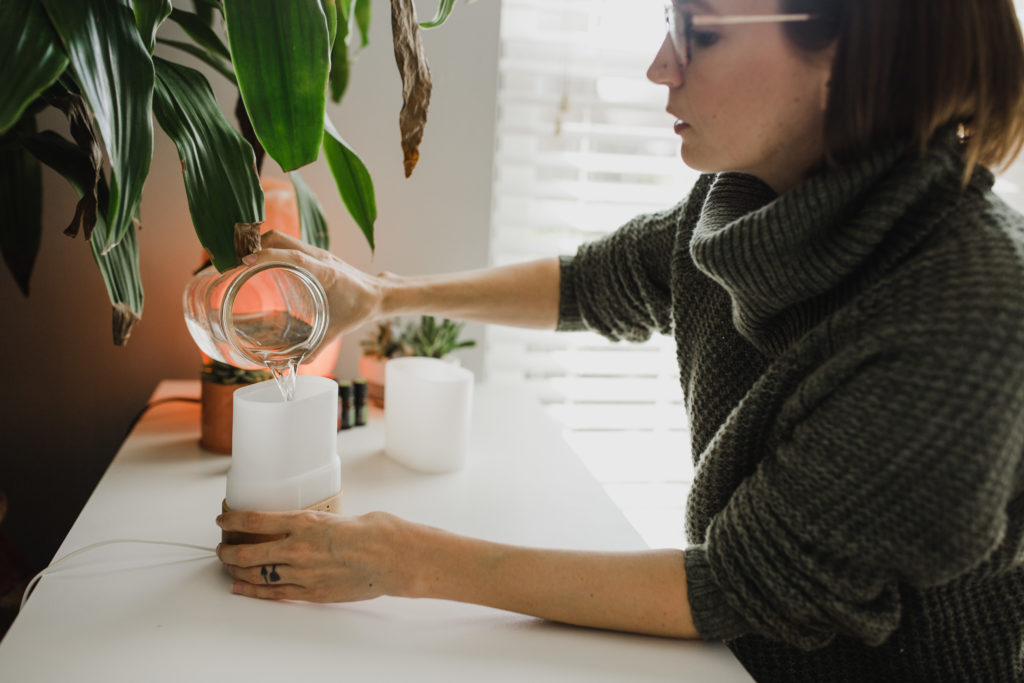 Tara pouring water into a diffuser