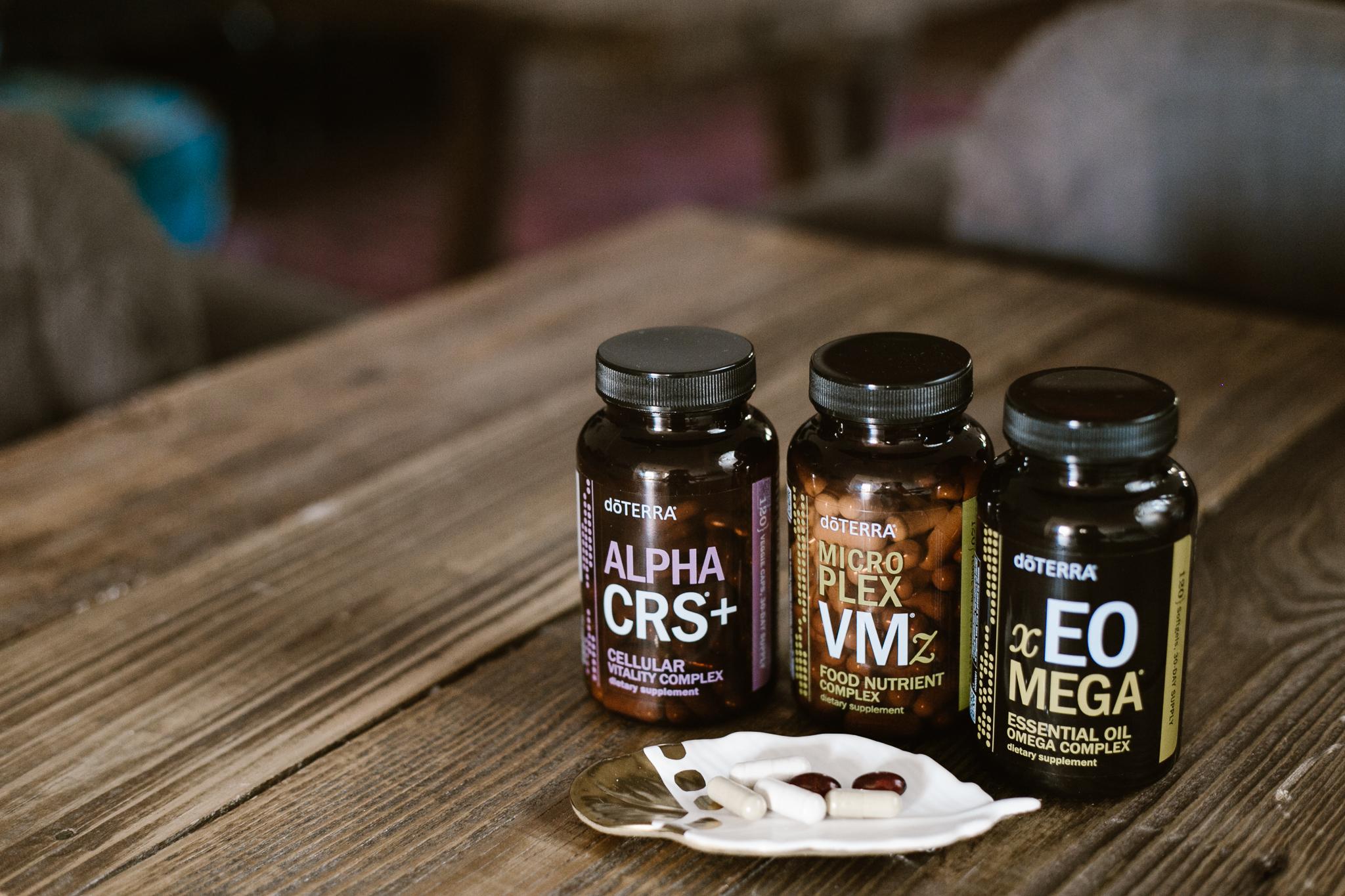 doTERRA Long Life Vitality supplements on wood table