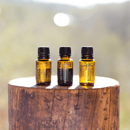 doTERRA essential oils on tree stump in sun