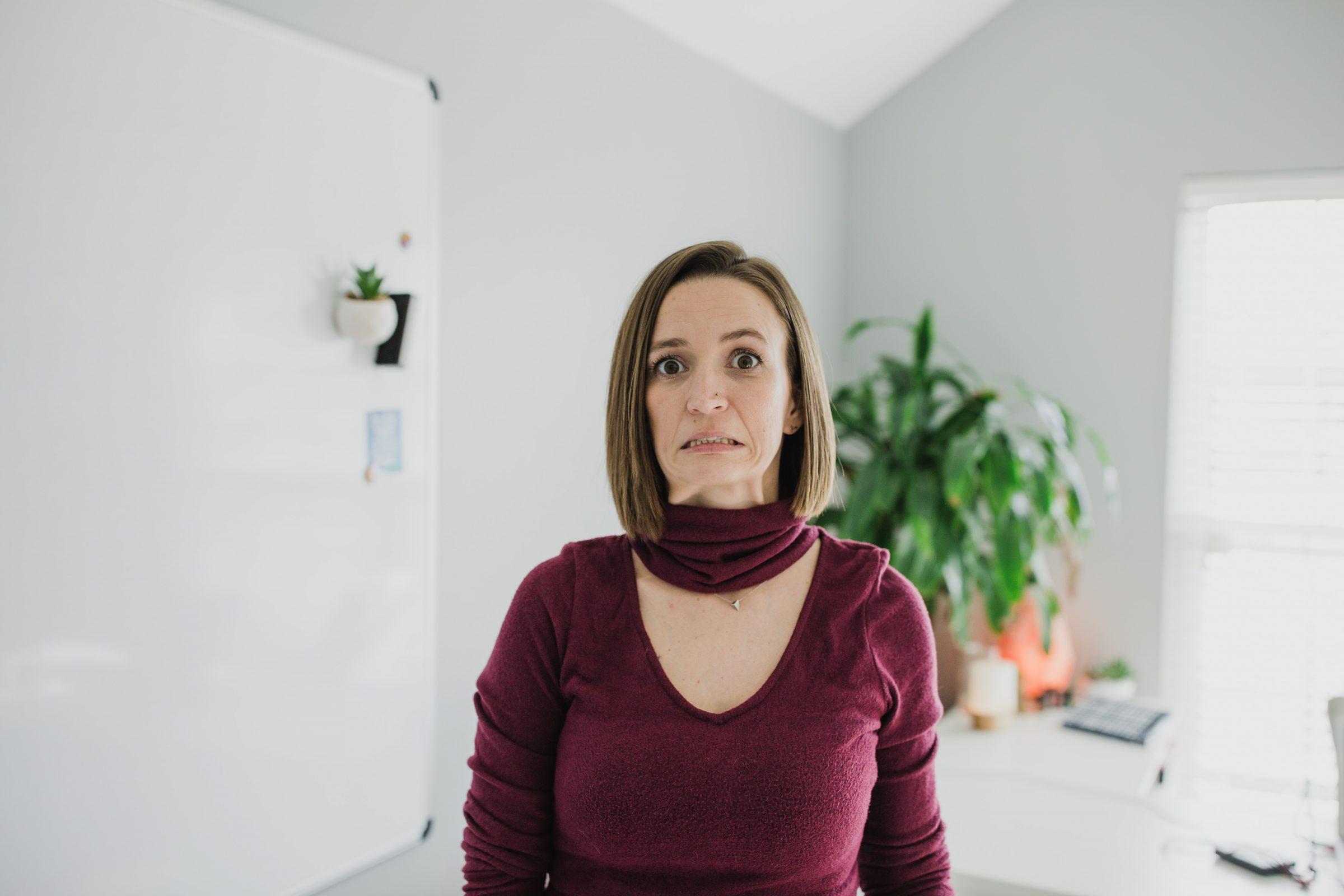 Tara wearing maroon long sleeve v-neck looking overwhelmed