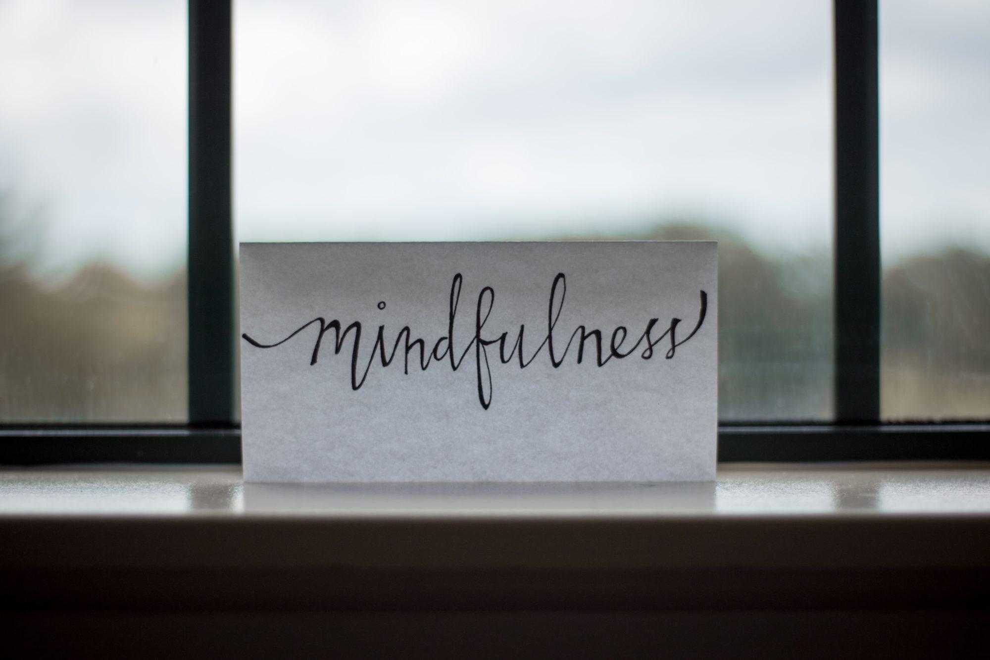 the word "mindfulness" on a piece of pape in the window