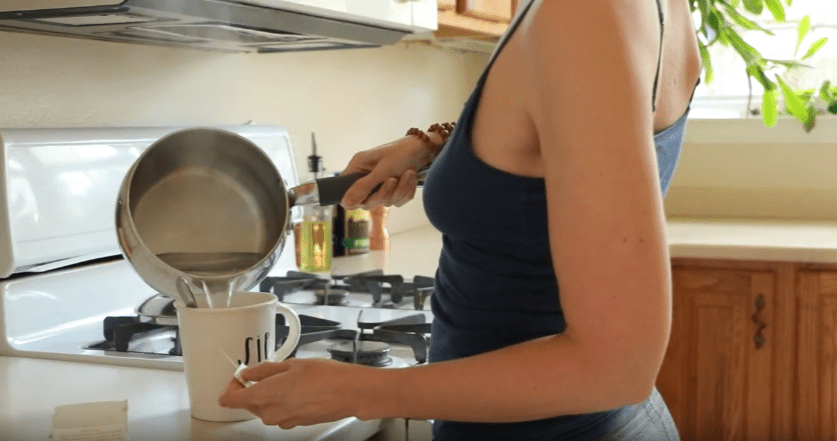 Tara pouring hot water from pot into mug