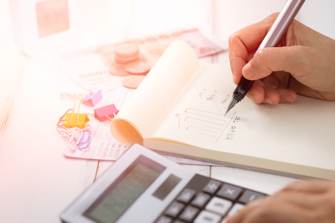 Woman calculating and writing