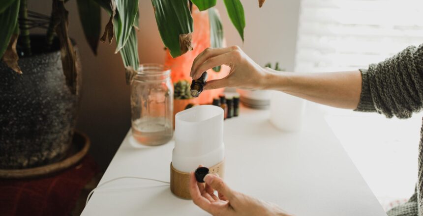 Tara's hands filling a diffuser on her desk