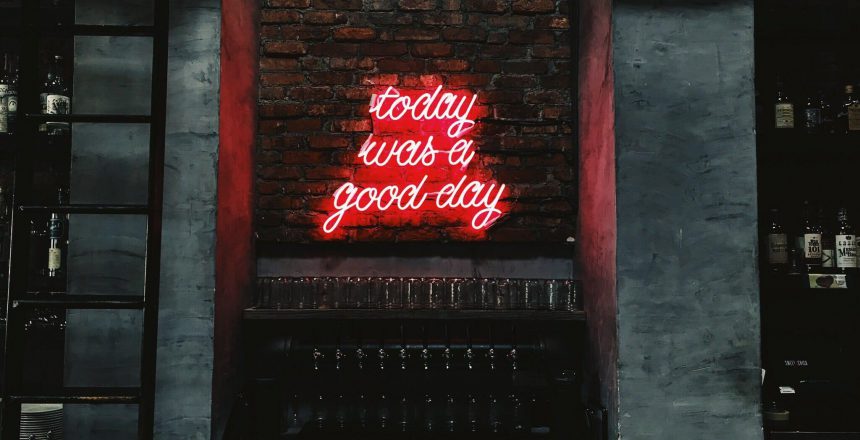 red neon sign on brick wall that says "today was a good day"