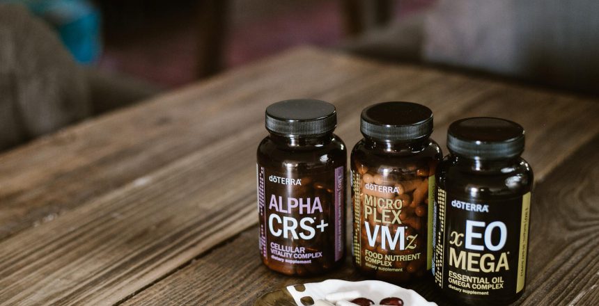 doTERRA Long Life Vitality supplements on wood table