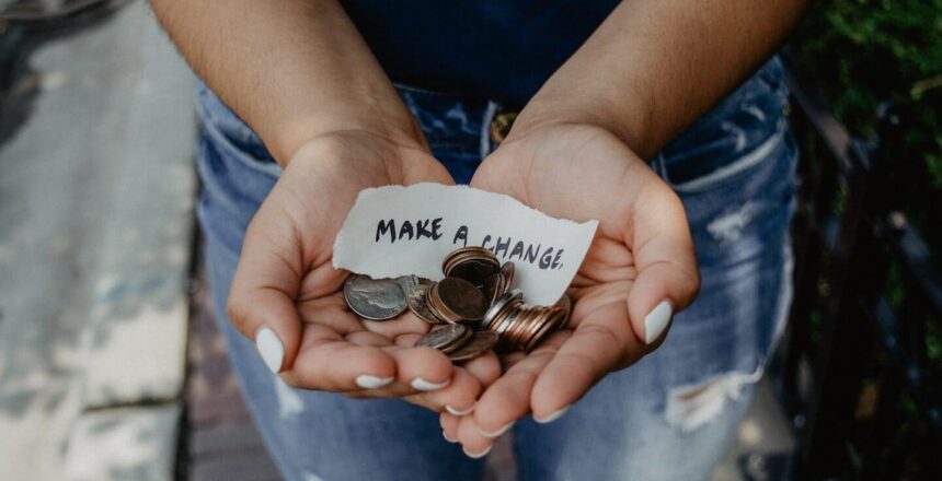 hands full of change with a piece of paper that says "make a change"