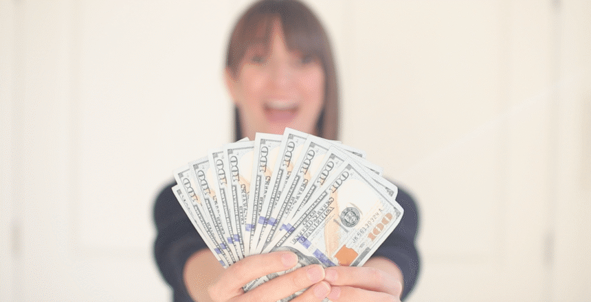Tara out of focus holding money in focus