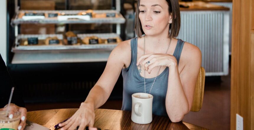 Tarain gray tank top explaining doTERRA oils in coffee shop
