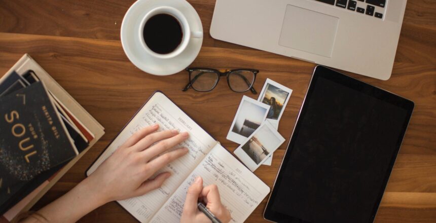 girl writing in journal in workspace