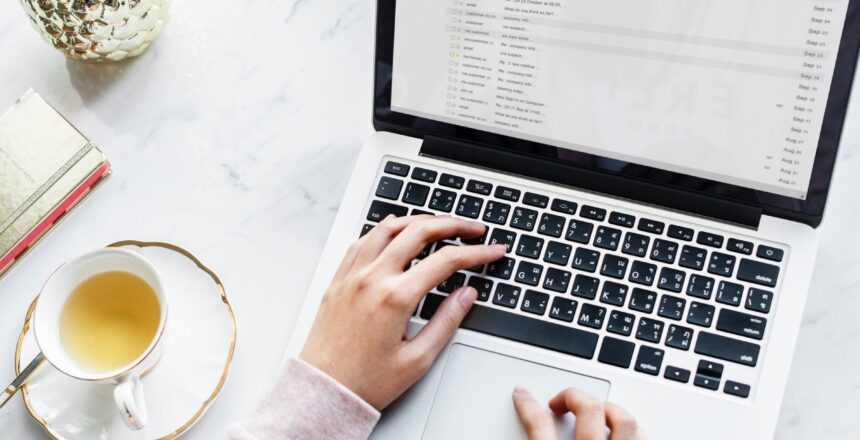 Woman working on laptop with tea