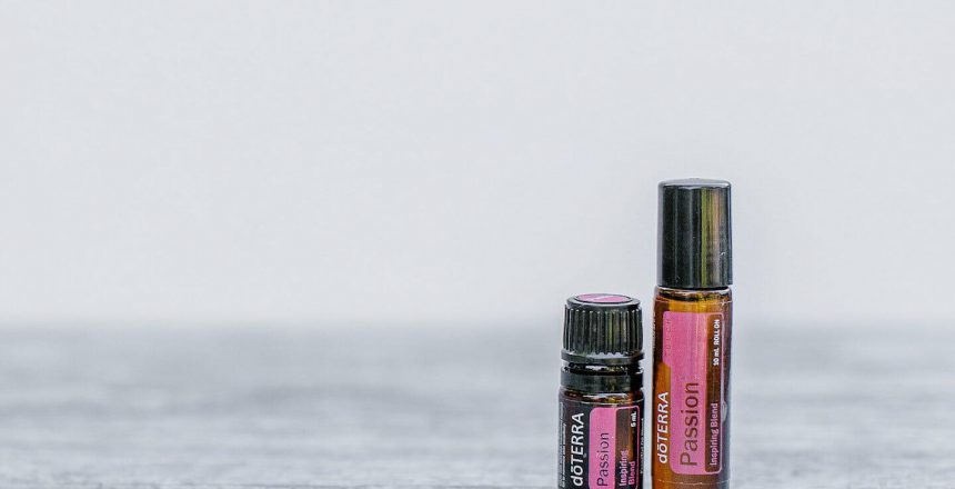 Passion Essential Oil 15ml bottle and rollerbottle side by side on table