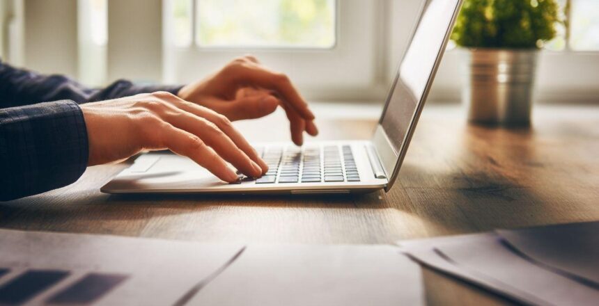 hands typing on lap top