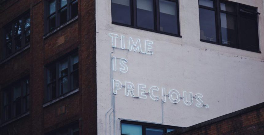 neon sign that says time is precious